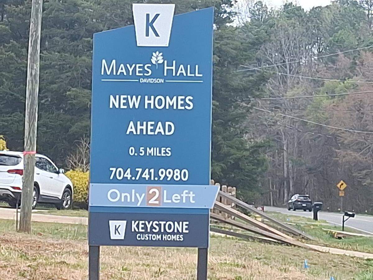 A sign for the Mayes Hall community at 13300 Mayes Road in Davidson on Thursday, March 20, 2025, said only two home sites were still available.&nbsp;&nbsp;