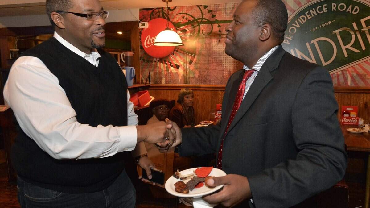 District Court Judge Gary Henderson (left) greets Mecklenburg Commissioner Trevor Fuller during an election viewing party in 2014. On Friday, Henderson was publicly reprimanded by the state Supreme Court for taking almost 2 1/2 years to rule in a routine case.