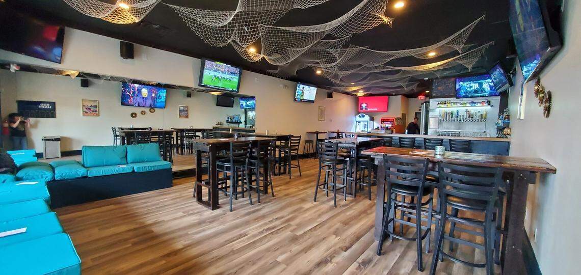 The Hideaway LKN co-owner Tina Kleinschmidt de-stressed and painted the bar to help cultivate a vintage Lake Norman vibe, along with nautical nets strung across the ceiling and artwork hung on the walls.