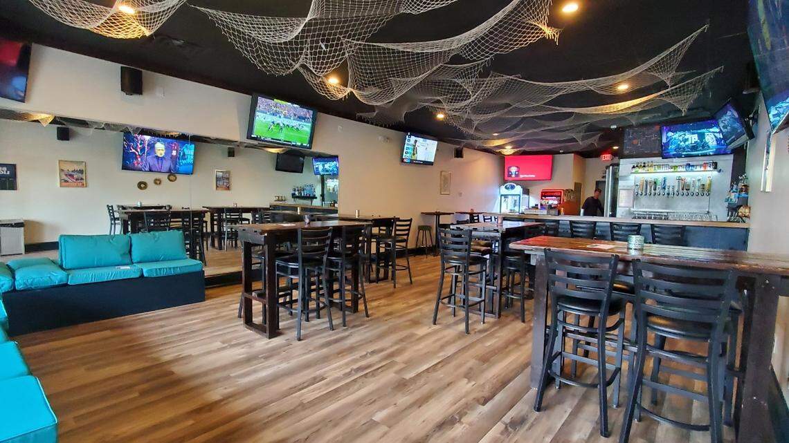 The Hideaway LKN co-owner Tina Kleinschmidt de-stressed and painted the bar to help cultivate a vintage Lake Norman vibe, along with nautical nets strung across the ceiling and artwork hung on the walls.