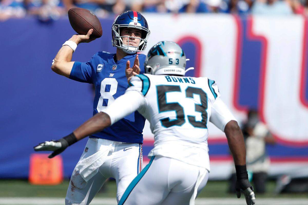New York Giants quarterback Daniel Jones, left, looks to throw during the first half Sunday. Brian Burns (53) sacked Jones twice Sunday.
