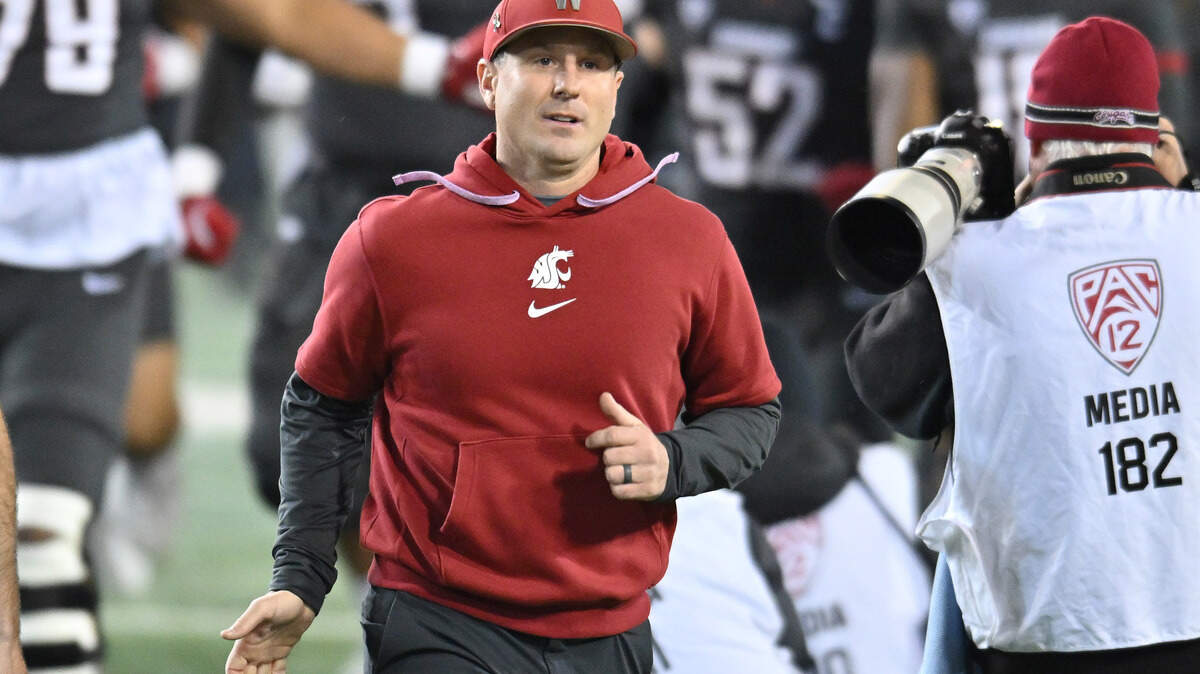 Nov 9, 2024; Pullman, Washington, USA; Washington State Cougars head coach Jake Dickert runs onto the field before a game against the Utah State Aggies at Gesa Field at Martin Stadium.