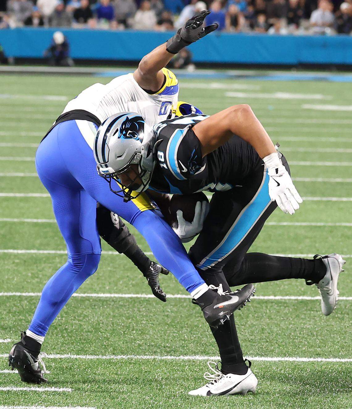 Carolina Panthers wide receiver Jalen Coker, right, turns for yardage following a pass reception from quarterback Bryce Young during action against the Los Angeles Rams at Bank of America Stadium on Saturday, January 10, 2026. The Rams defeated the Panthers 34-31.