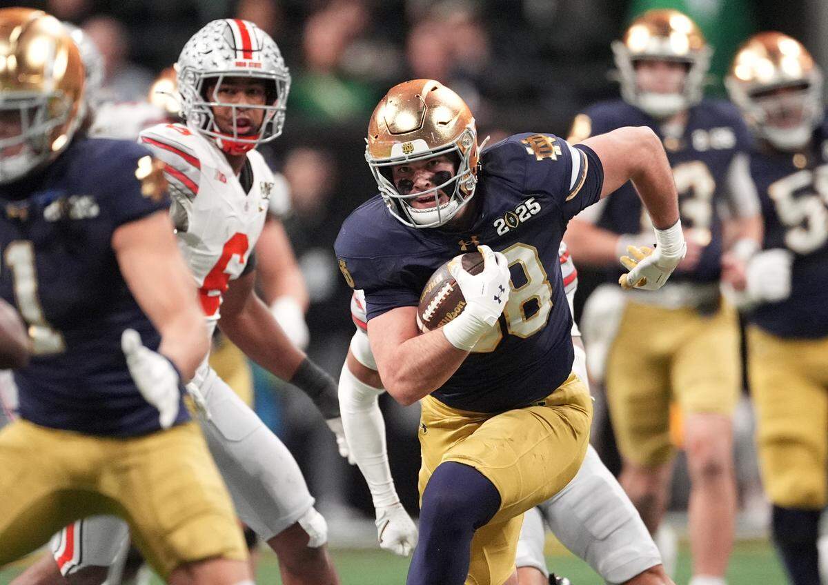 Notre Dame Fighting Irish tight end Mitchell Evans (88) runs after a catch against the Ohio State Buckeyes in the second half in the CFP title game at Mercedes-Benz Stadium. Dale Zanine-Imagn Images