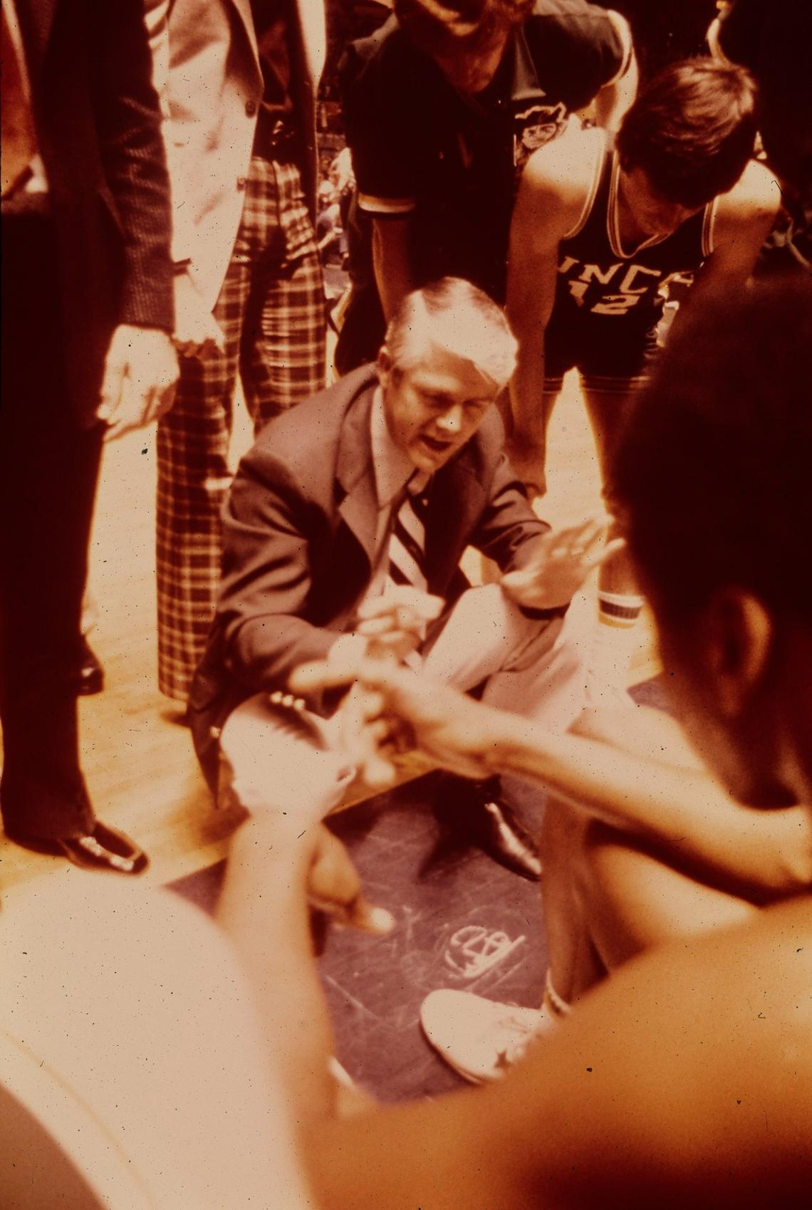 Lee Rose gives instruction in a Charlotte 49ers huddle. Rose coached the 49ers to their lone Final Four berth in 1977.