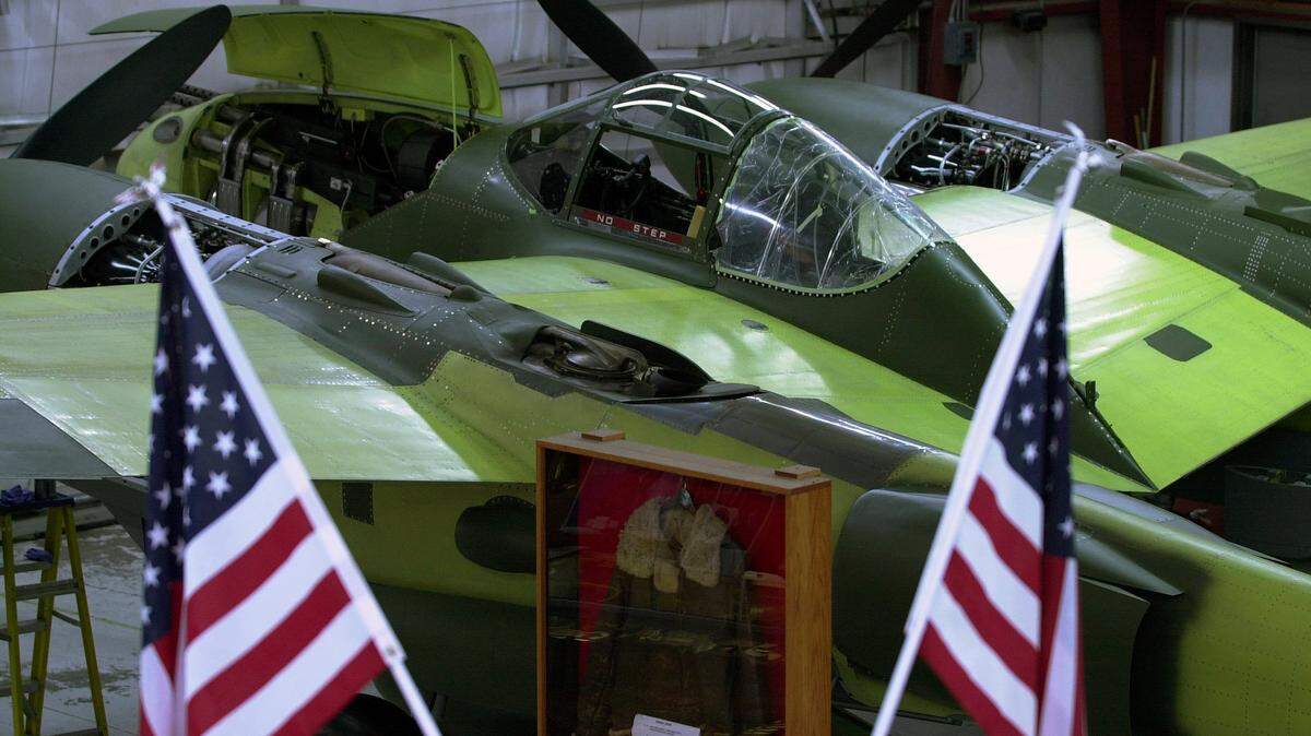 The restoration of Glacier Girl a P38 Lighting nears completion. On Friday, Feb. 8, 2001 the plane waits for completion . The jacket in the case in middle of the picture is a US Air Corps 1942 issued cold weather flight jacket that was found durning the pulling the plane from the ice. In May of 1992, a P-38 Lighting fighter plane, the Glacier Girl was pull from the Ice in Greenland where it had crashed on July 15, 1942 durning World War II. J. Roy Shoffner, Middlesboro, Ky. funded and helped in the expredition to remove plane and to retore and fly it. The project at first was $1.2 million and was to take about 18 months to complet restoration on the plane that was one of The Lost Squardron, Glacier Girl 17630 . Now 10 years later and $3 million plus, the plane is about 3 months away from completion. The plane is being restored at the Lost Squadron Museum that is located at the Middlesboro, Ky.,/Bell county airport. It is open 7 days a week and admission is free.