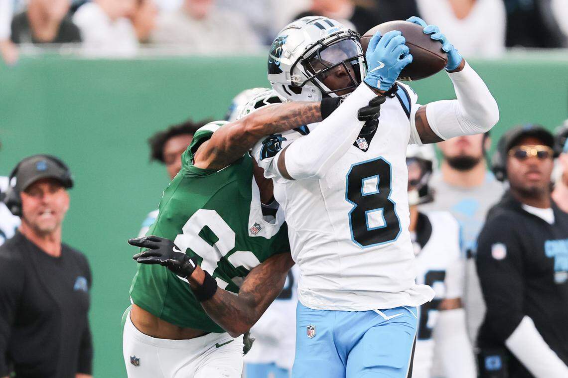 Oct 19, 2025; East Rutherford, New Jersey, USA; Carolina Panthers cornerback Jaycee Horn (8) intercepts the ball intended for New York Jets wide receiver Josh Reynolds (83) in the fourth quarter at MetLife Stadium. Mandatory Credit: Vincent Carchietta-Imagn Images
