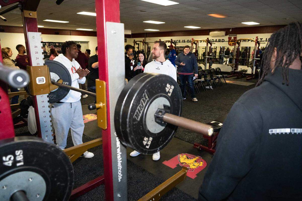 Carolina Panthers wide receiver Adam Thielen chats with student-athletes from Harding University in Charlotte in the school’s newly renovated weight room.