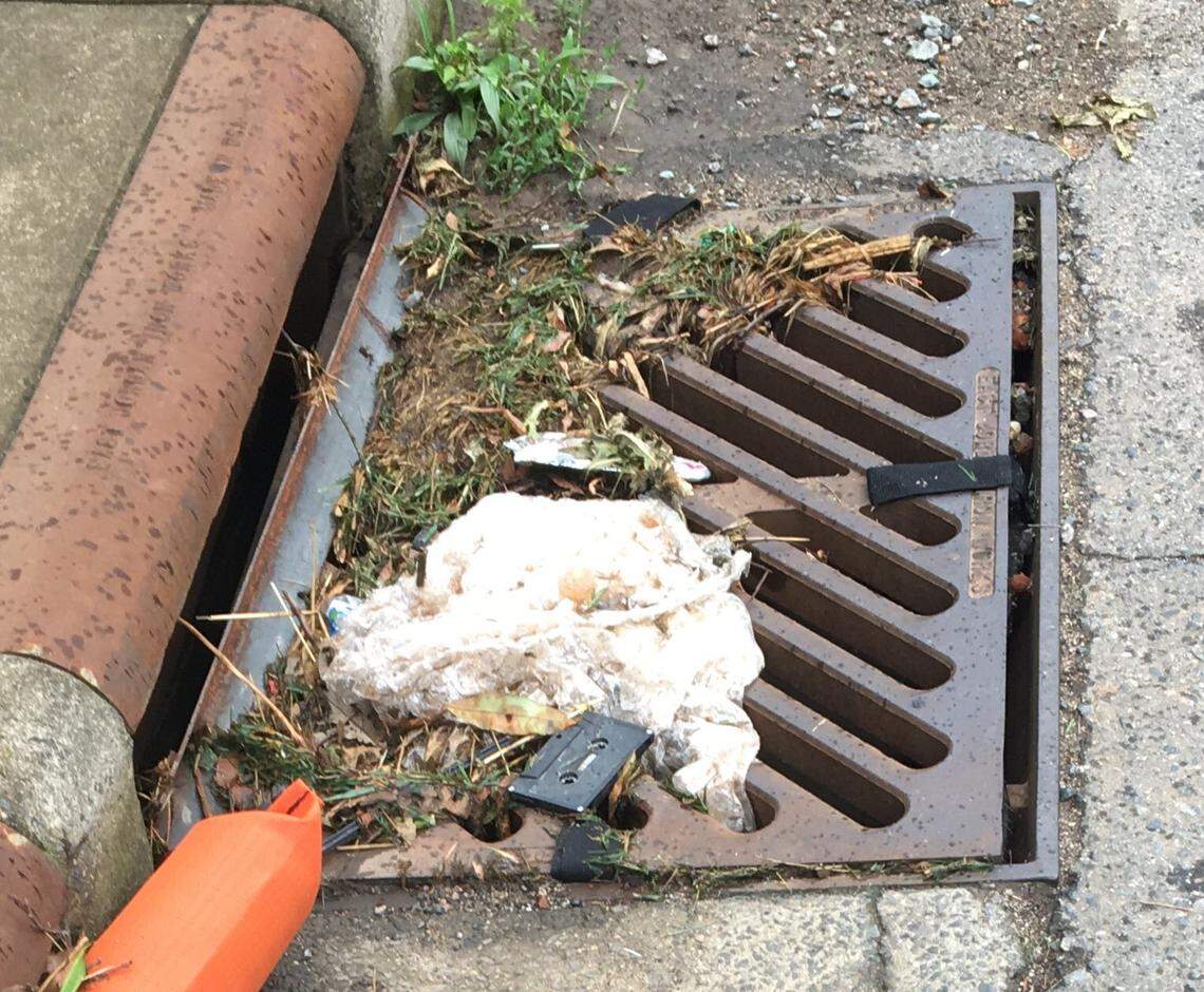 A storm drain in Charlotte clogged with debris on Ideal Way.