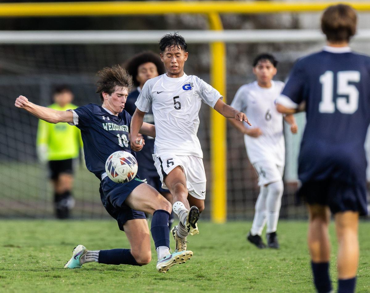 Weddington Warriors Pierce Cooper, left, collides with Garinger Wildcats Daniel Escobar at Weddington High School in Matthews, N.C., on Wednesday, August 28, 2024.