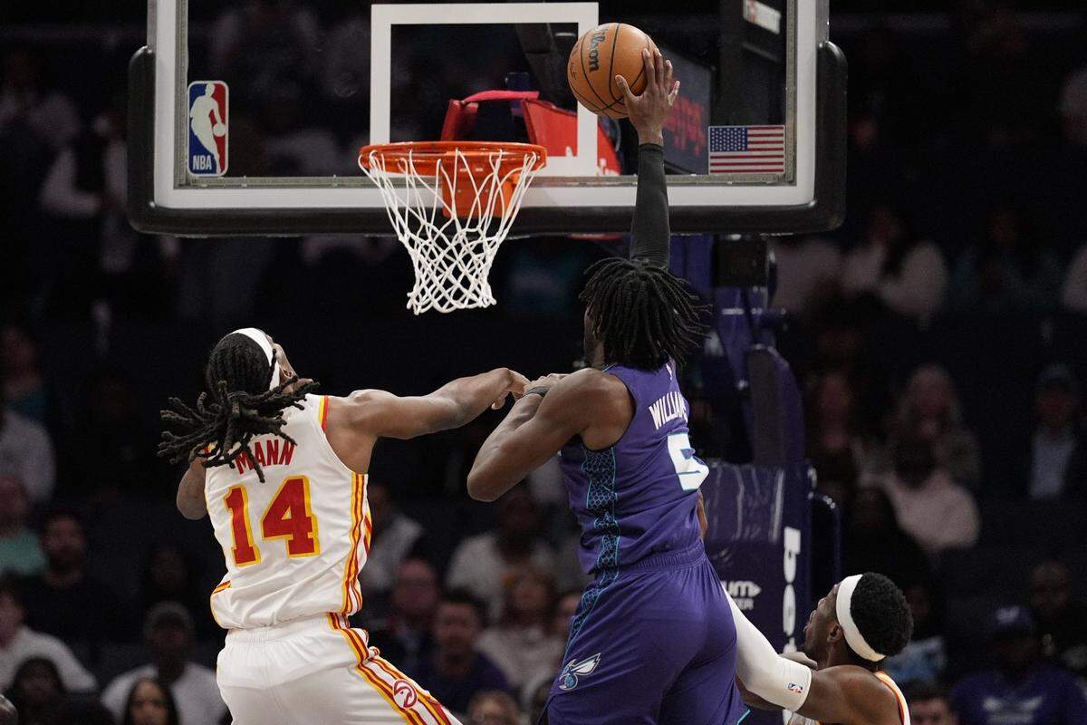 Charlotte Hornets center Mark Williams (5) goes to the basket against Atlanta Hawks guard Terance Mann (14) during second quarter at Spectrum Center.