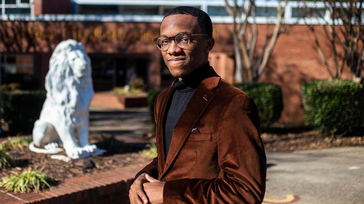 Malachi Thompson, a sophomore, standing outside West Charlotte High School on Dec. 23, 2021 in Charlotte. He says he and others on campus largely feel safe but the presence of guns recently is troubling.