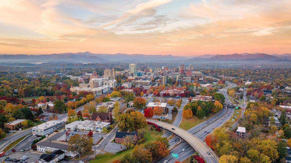 The Asheville skyline at sunrise over Town Mountain Road Bridge in the fall.