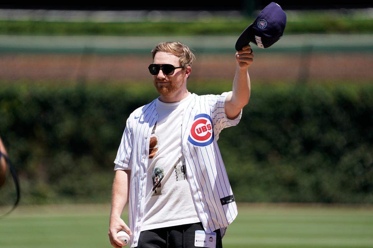 Tyler Reddick prepares to throw out the ceremonial first pitch before the game between the Chicago Cubs and the Los Angeles Angels at Wrigley Field on July 5, 2024, in Chicago.