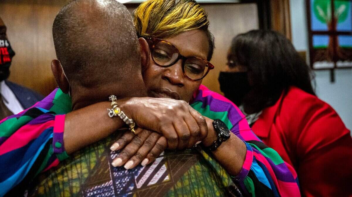 Ahmaud Arbery’s mother, Wanda Cooper-Jones is hugged by a supporter after the jury convicted Travis McMichael in the trial of McMichael, his father, Greg McMichael, and neighbor, William “Roddie” Bryan, Wednesday, Nov. 24, 2021, in the Glynn County Courthouse in Brunswick, Ga. The three defendants were found guilty Wednesday in the death of Ahmaud Arbery.