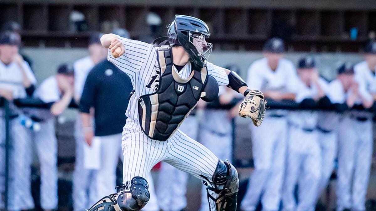 Providence Catcher Sam Fligel looks to make the out at 3rd base.