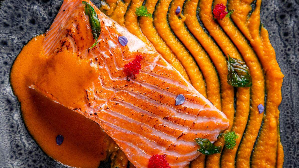 Roasted salmon steak with pumpkin cream on plate