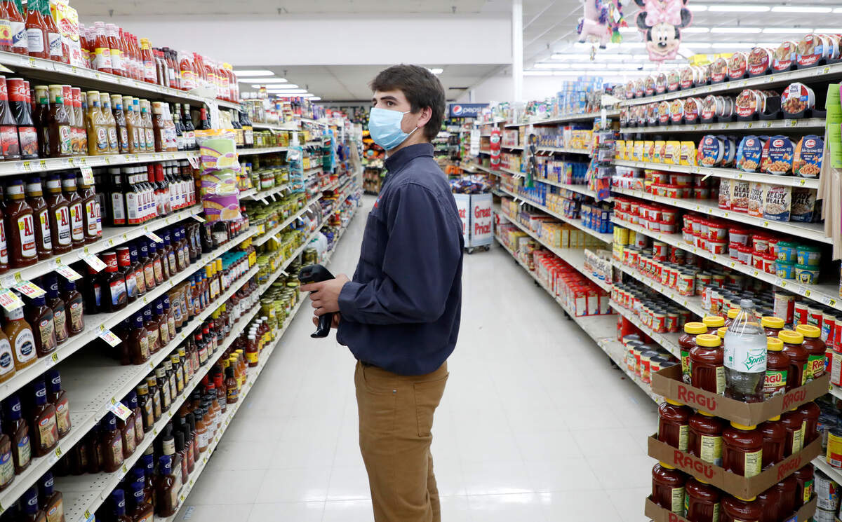 Johnny Grizzard, grocery manager at the Carlie C’s IGA in Angier, N.C., works Tuesday, April 14, 2020.
