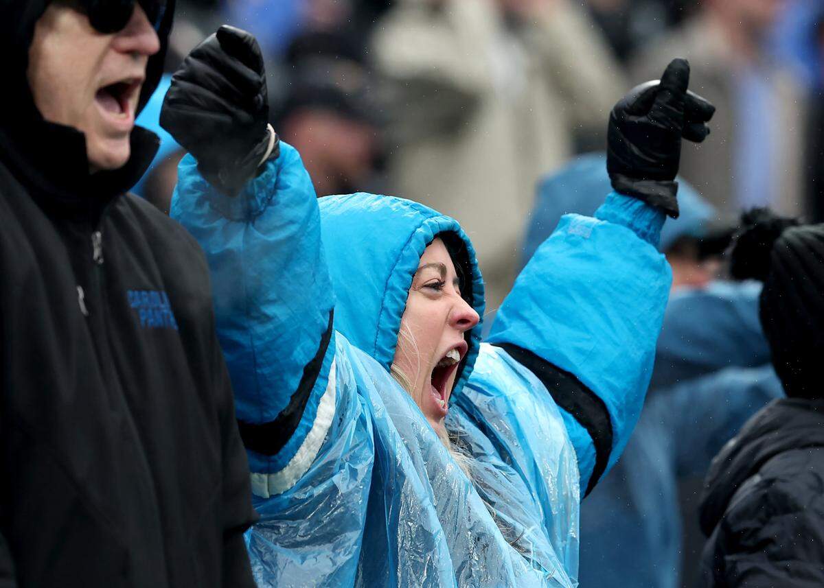 A fan celebrates Carolina Panthers quarterback Bryce Young and wide receiver Tetairoa McMillan's pass and touchdown reception during fourth quarter action against the Los Angeles Rams at Bank of America Stadium in Charlotte, NC on Sunday, November 30, 2025. The Panthers defeated the Rams 31-28.