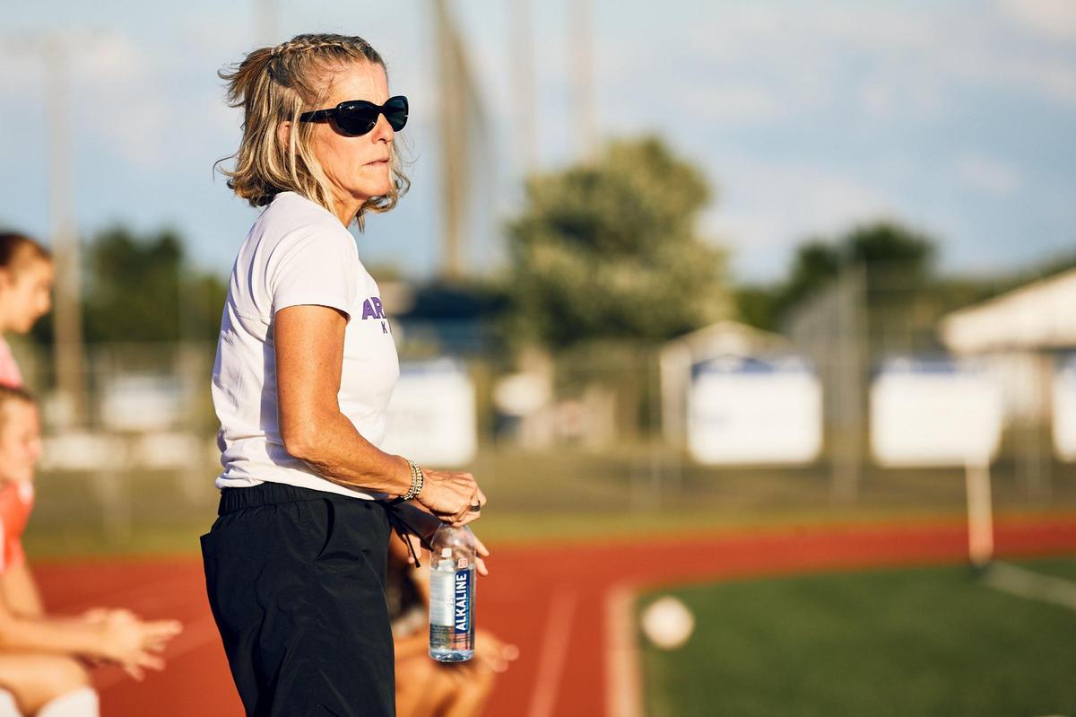 Ardrey Kell Head Coach Kim Montgomery looks on as her players continue to challenge the Hickory Ridge defense in the NCHSAA Quarterfinals in Harrisburg, NC on May 22, 2025.
