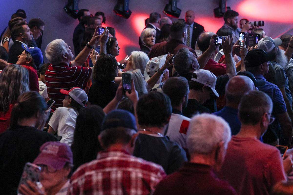 Supporters pull out their cell phones at the urging of Senator JD Vance, the GOP vice presidential candidate, as he encourages them to send a photo from the event to ten friends and tell them to vote on election day, during a rally at Freedom House Church in Charlotte, NC on Monday, September 23, 2024.