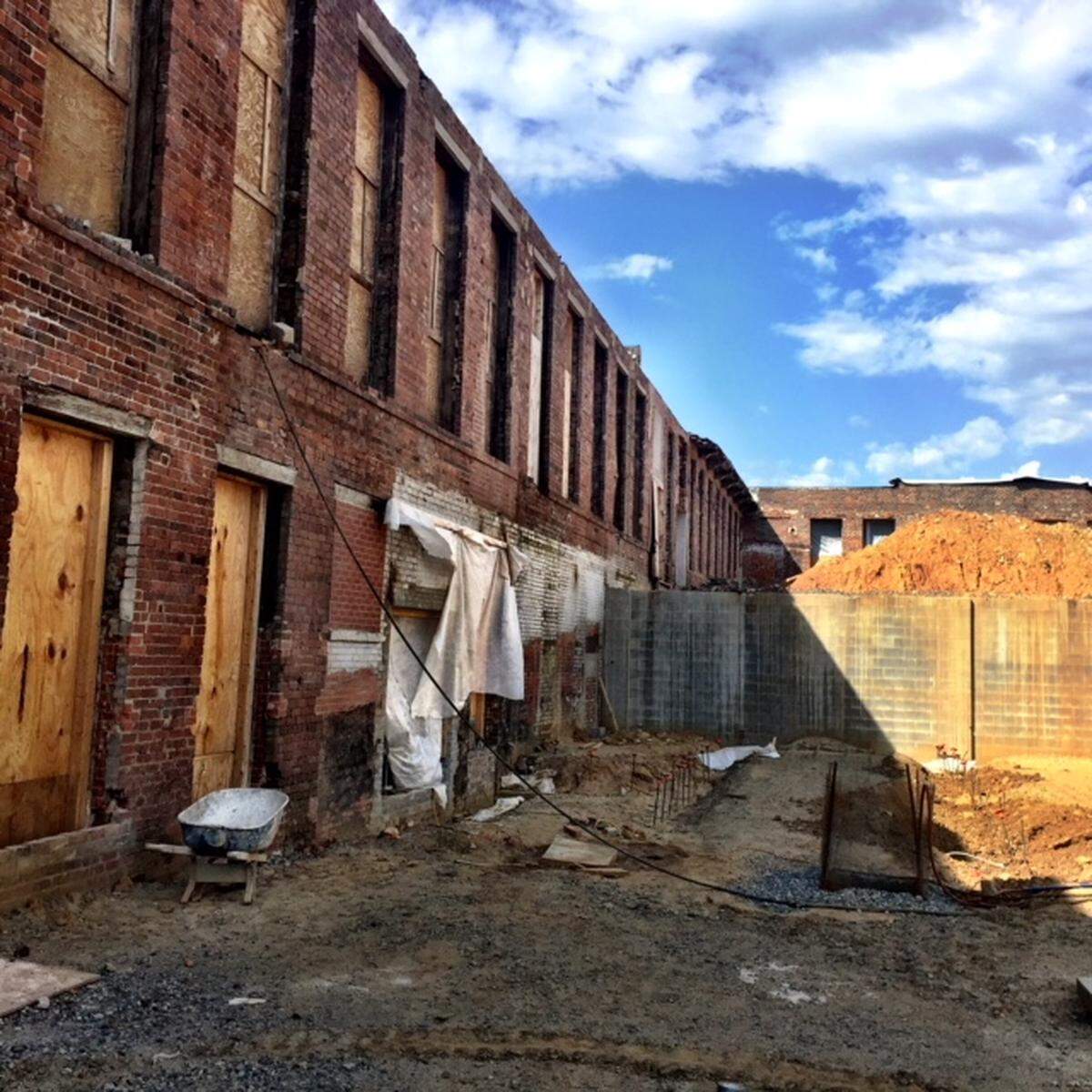 Tompkin Hall's original brick exterior is being restored, with a section that will become a multi-level outdoor seating area between Fonta Flora Brewery's tasting room and up to three restaurants in the space on the left.