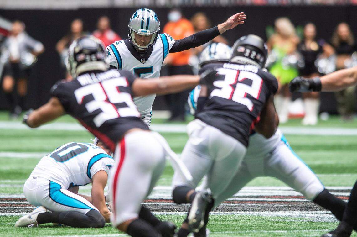 Panthers kicker Zane Gonzalez, back center, kicks a fifty-seven yard field goal to bring the Panthers within one point of the Falcons before the half during the game at Mercedes-Benz Stadium on Sunday, October 31, 2021 in Atlanta, GA.