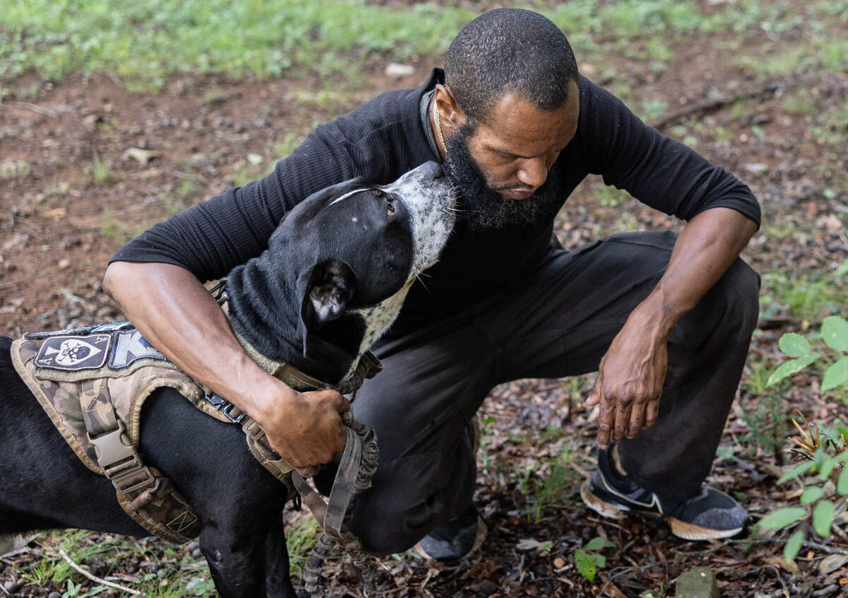 Kenneth Tolbert and his dog, Cosmo, found a 16-year-old girl hanging in a churchyard in north Charlotte. He does not believe the police’s determination that she died by suicide.