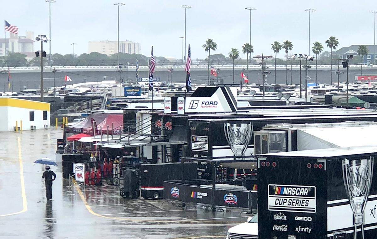 A lone person walks through the NASCAR Cup garage at Daytona International Speedway on Sunday, Feb. 18, 2024. The Daytona 500 was postponed until Monday, Feb. 19th, due to constant rain.
