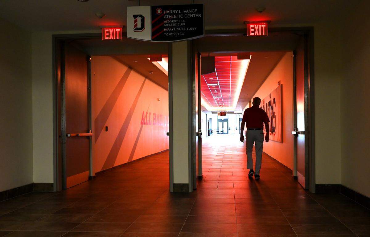 Former Davidson College head basketball coach Bob McKillop walks toward an exit outside the school’s Belk Gym, where he coached for decades.