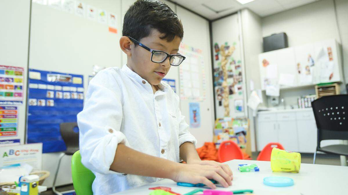 Miguel Mendieta, 8, oldest son of Maria Belen Mendieta, makes shapes with Play-Doh at the Cato Education Center at Harris YMCA. Mendieta received assistance through the program when she was a first time mother and ended up helping with the Parents as Teachers program. Mendieta said participating in the various programs not only helped her grow as a person, it also provided a full circle moment for her. She now works as an ESL-YKids associate, where she provides activities for children of the Y’s ESL students while they are in class.