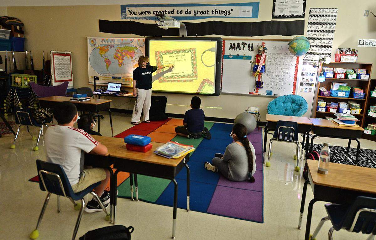 Lori Stalcup teaches fourth grade math to her students on Monday, August 17, 2020 at Sardis Elementary School in Monroe, NC. Teachers and students returned to the classroom with social distancing and masks on the first day of school. As of Thursday, no cases of coronavirus were reported from this school.