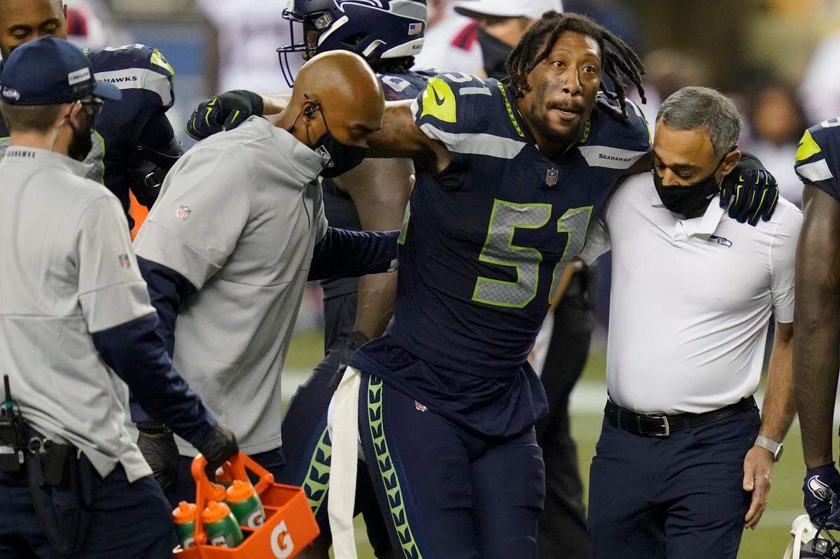 Seattle Seahawks linebacker Bruce Irvin, who played for Carolina in 2019, is helped off the field Sept. 20th. Irvin suffered a torn ACL and won’t return this season.