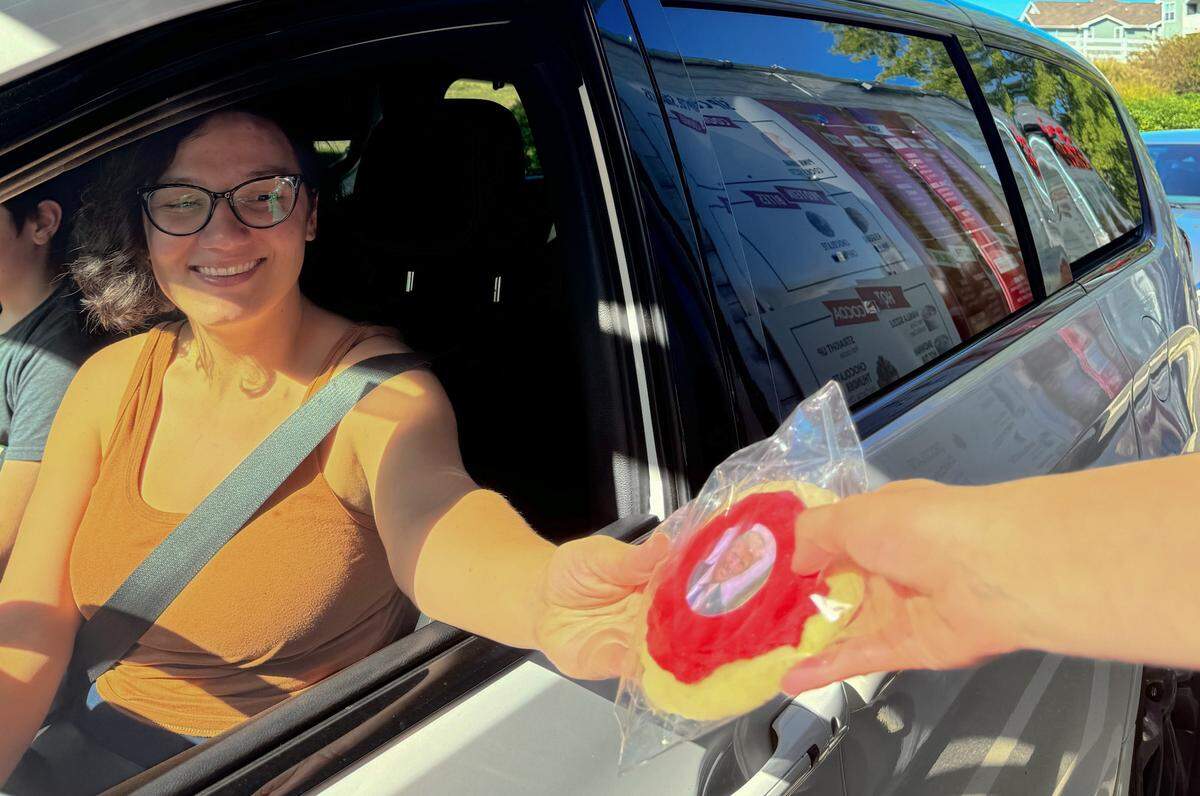 A Sip Co. customer selects a red cookie featuring former President Trump.