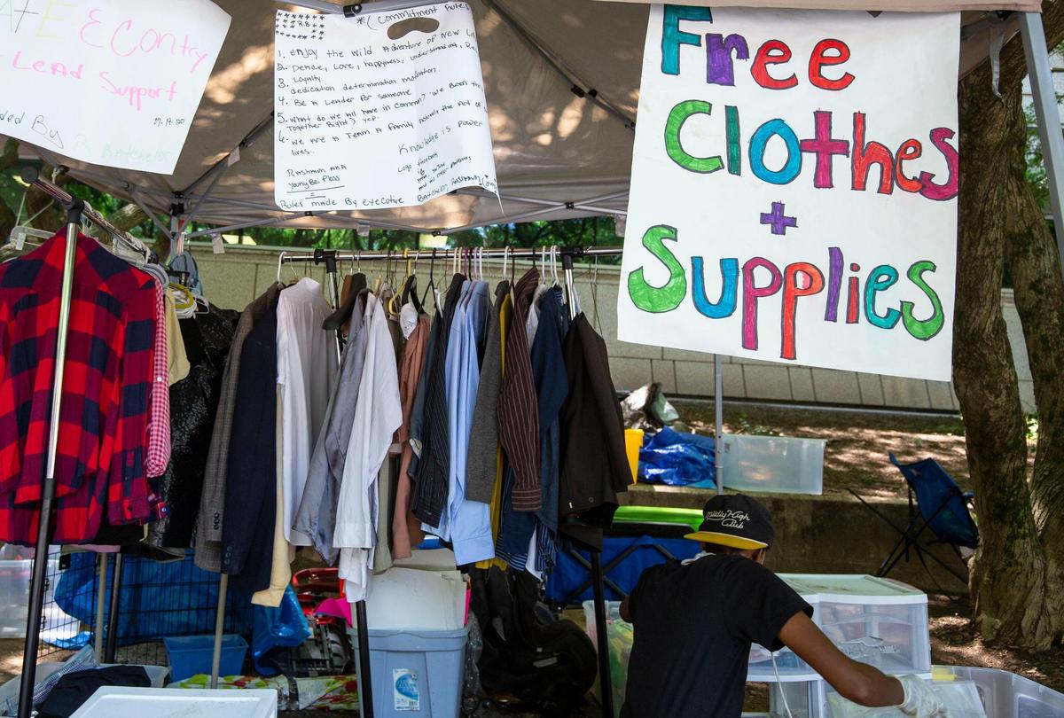Volunteers with Jail Support and Charlotte Uprising distribute clothes and basic items to those who are released from jail in Uptown Charlotte, NC on Monday, July 20, 2020. After dozens of arrests and tensions with the SheriffÕs Office the group moved from in front of the County Jail to across the street behind the Mecklenburg County Courthouse.