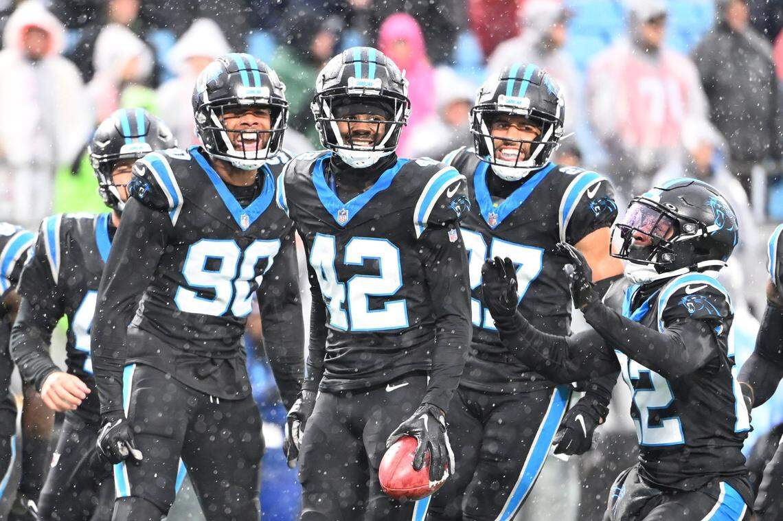 Dec 17, 2023; Charlotte, North Carolina, USA;  Carolina Panthers lspecial teams players inebacker Amare Barno (90) and safeties Sam Franklin Jr. (42) and Alex Cook (27) and Jammie Robinson (22) react in the first quarter at Bank of America Stadium. Mandatory Credit: Bob Donnan-USA TODAY Sports