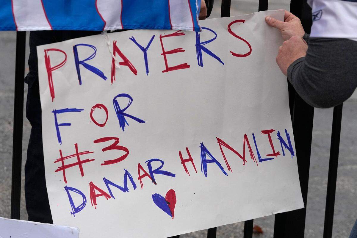A poster is attached to a fence outside of University of Cincinnati Medical Center, Tuesday, Jan. 3, 2023, in Cincinnati. Buffalo Bills’ Damar Hamlin was taken to the hospital after collapsing on the field during an NFL football game against the Cincinnati Bengals on Monday night.(AP Photo/Darron Cummings)
