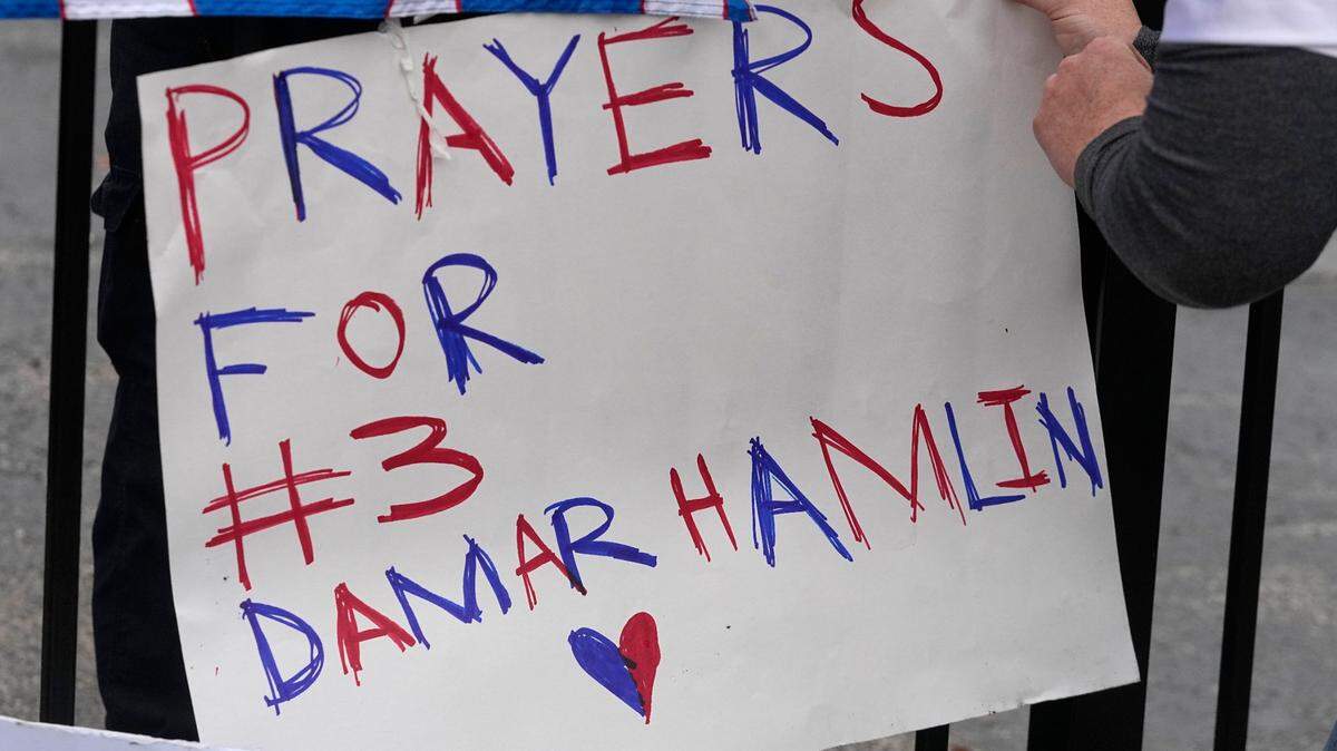 A poster is attached to a fence outside of University of Cincinnati Medical Center, Tuesday, Jan. 3, 2023, in Cincinnati. Buffalo Bills’ Damar Hamlin was taken to the hospital after collapsing on the field during an NFL football game against the Cincinnati Bengals on Monday night.