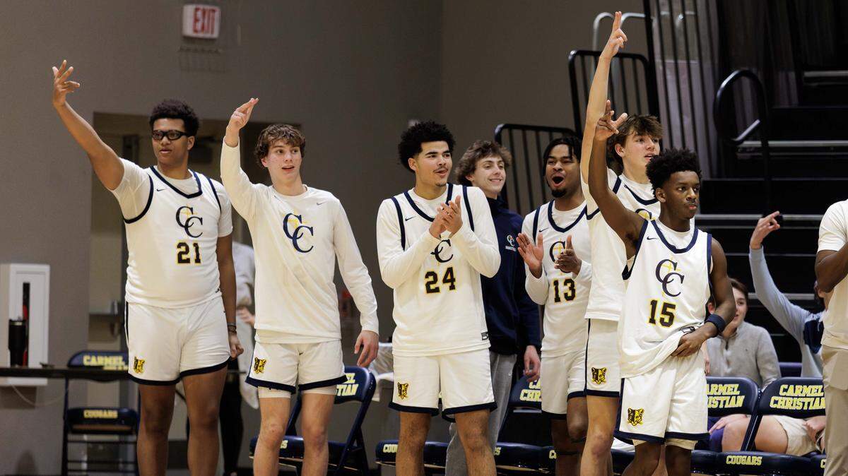 The Carmel Christian bench celebrates a made 3-point shot during early 1st half action. Carmel Christian would host Providence Day in the NCISAA state semifinal Tuesday February 18, 2025.