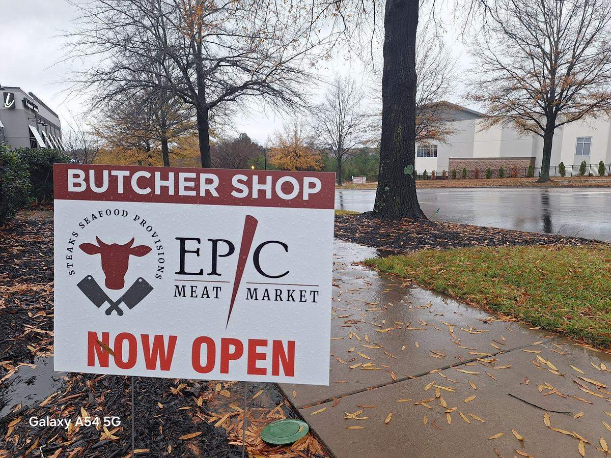 Epic Meat Market, a popular Lake Norman butcher shop, still has a “Now Open” sign facing drivers despite a handwritten “closed until further notice” message on its door.