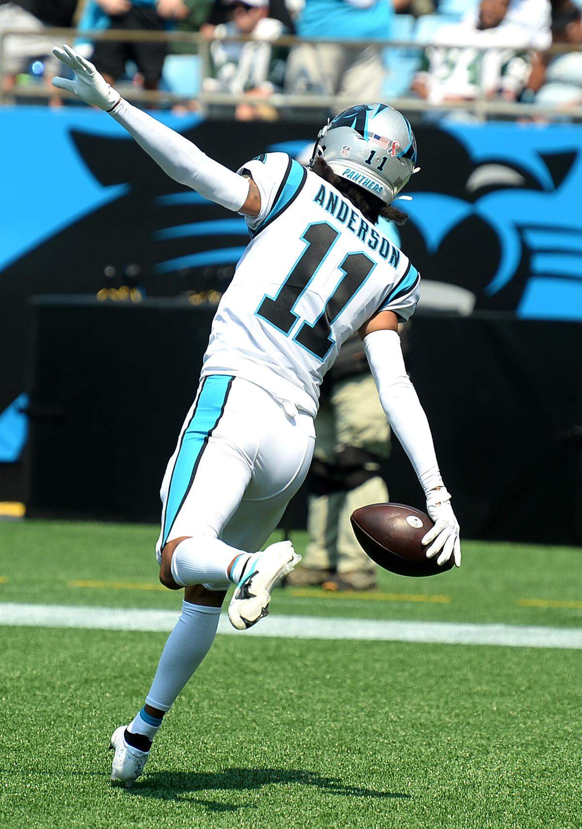 Carolina Panthers wide receiver Robby Anderson runs through the end zone like an airplane after catching a deep touchdown pass against the New York Jets during second-quarter action. The Panthers defeated the Jets 19-14.