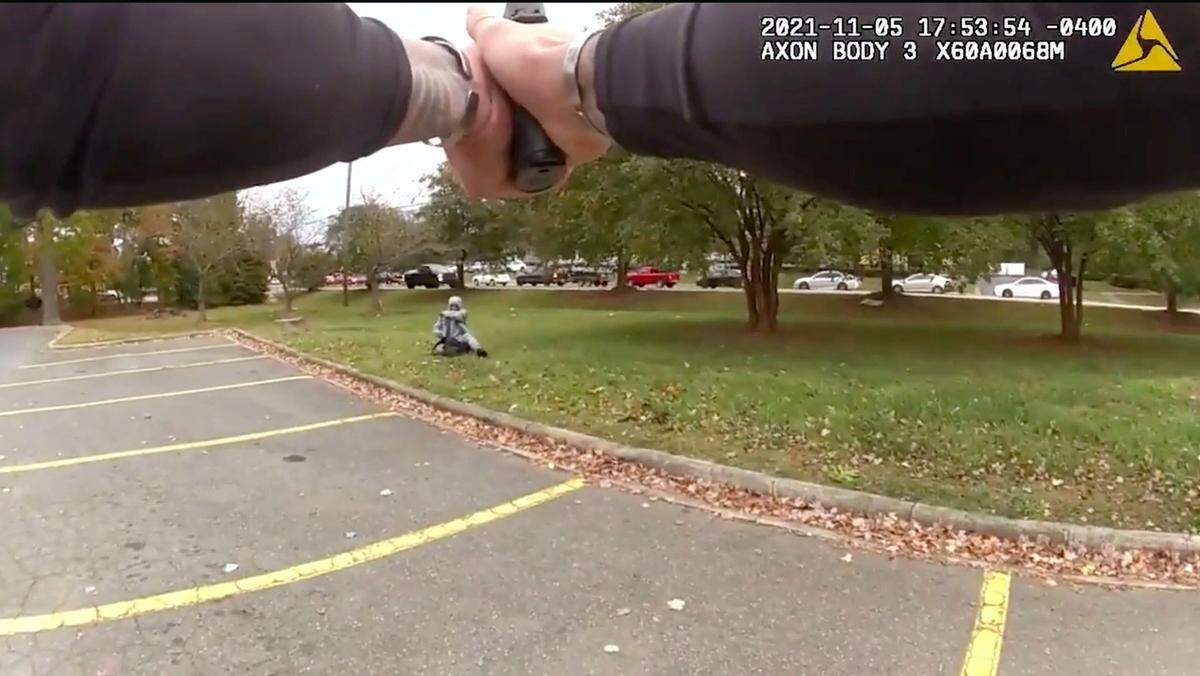 In this image from Charlotte-Mecklenburg Police video, an officer points his service weapon at Derrell Lamar Raney at an Albemarle Road shopping center on Nov. 5, 2021. Officers Micah Edmunds and James Longworth perceived a lethal threat and fatally shot Raney, police said.