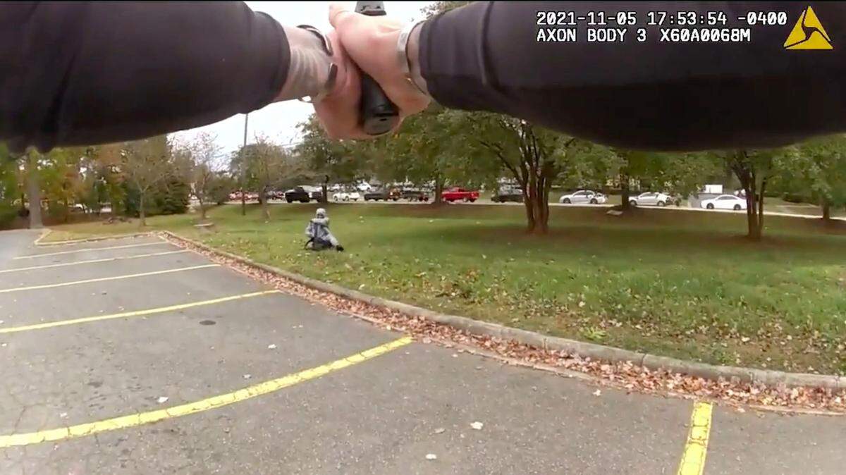 In this image from Charlotte-Mecklenburg Police video, an officer points his service weapon at Derrell Lamar Raney at an Albemarle Road shopping center on Nov. 5, 2021. Officers Micah Edmunds and James Longworth perceived a lethal threat and fatally shot Raney, police said.
