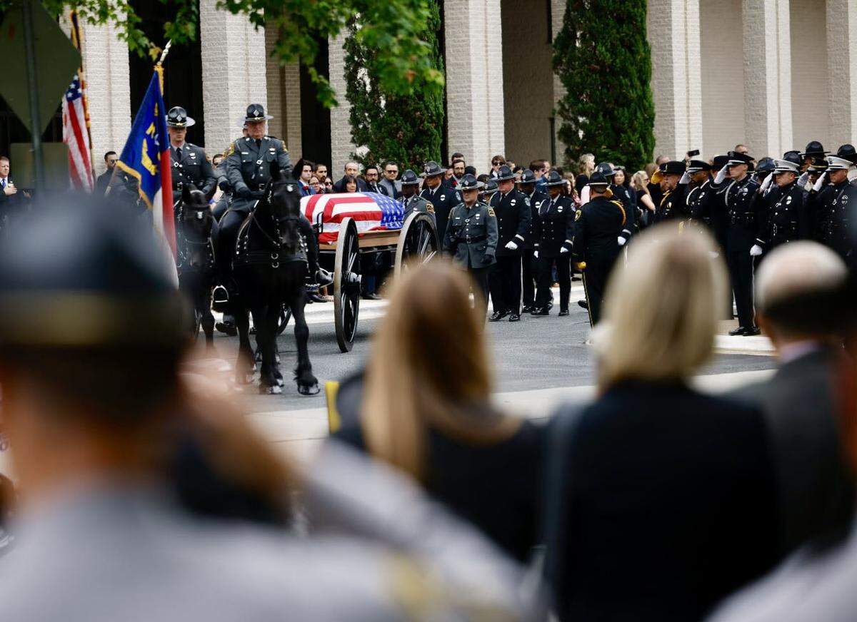A caisson procession&nbsp;for Investigator Sam Poloche of the N.C. Department of Adult Correction makes its way to First Baptist Church in Charlotte for the memorial service on Monday, May 13, 2024. Poloche killed in the line of duty while serving a warrant in east Charlotte on Monday April 29, 2024.