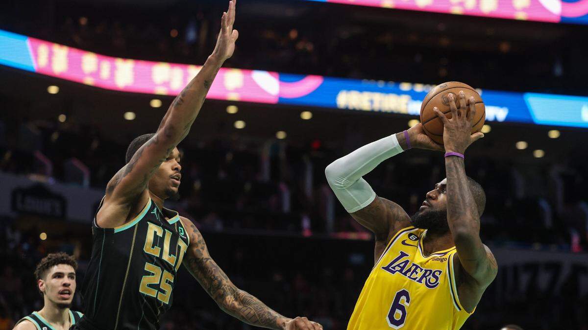 Hornets forward PJ Washington, left, defends the Los Angeles Lakers’ LeBron James as he shoots a fadeaway jumper during the game at Spectrum Center on Monday, January 2, 2023. James scored 43 points as the Lakers beat the Hornets, 121-115.