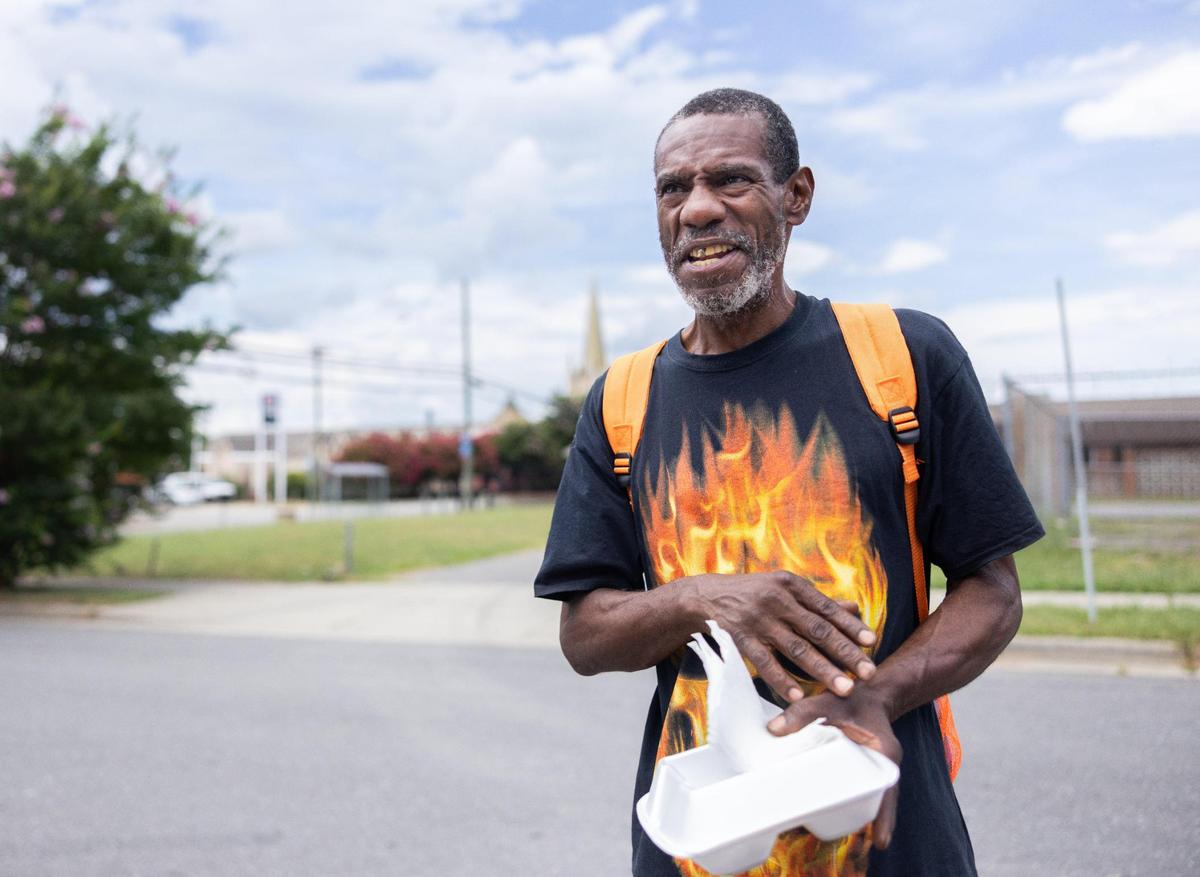 James Patton talks about his experience with fentanyl overdose and problems he has seen in his community while he holds a boxed lunch he received at Hajee House Harm Reduction in Charlotte on July 17.