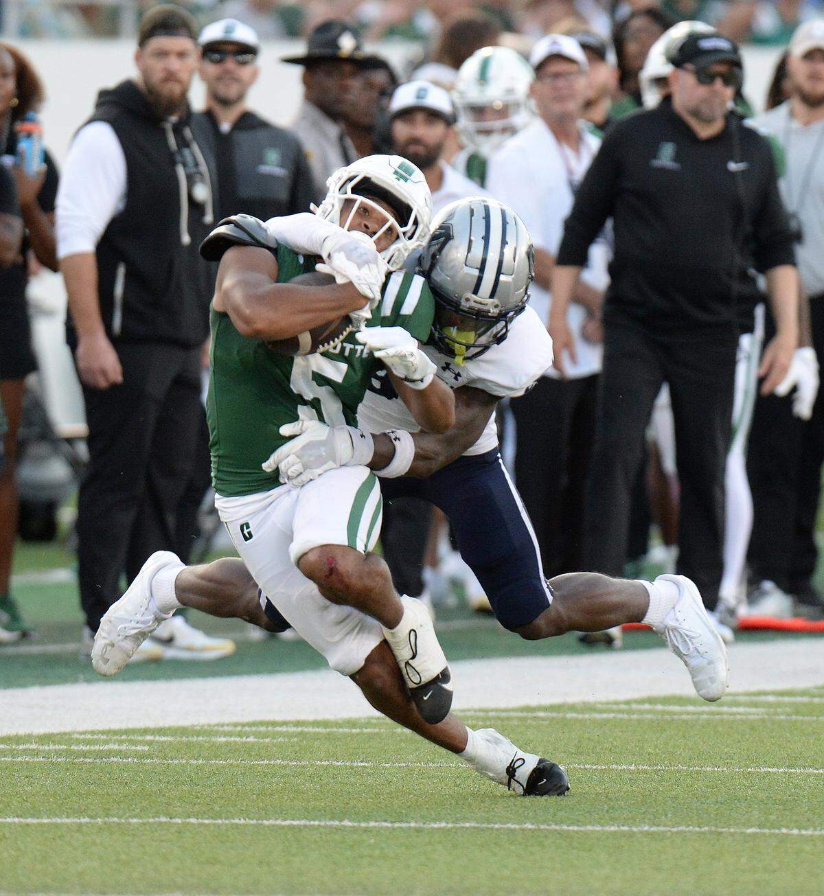 Charlotte's Javen Nicholas (5) is tackled after a first-half gain in the first half of the 49ers’ game against Monmouth at Jerry Richardson Stadium in Charlotte on Saturday.