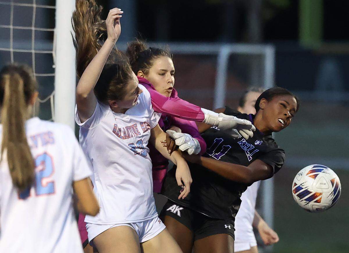Ballantyne Ridge goalie Bella Frankel, center, fights to stop a shot on goal with Ardrey Kell’s Kelley Tarpley, right, during girls soccer action at Ardrey Kell High School on Tuesday, April 28, 2026. Ardrey Kell defeated Ballantyne Ridge 1-0.