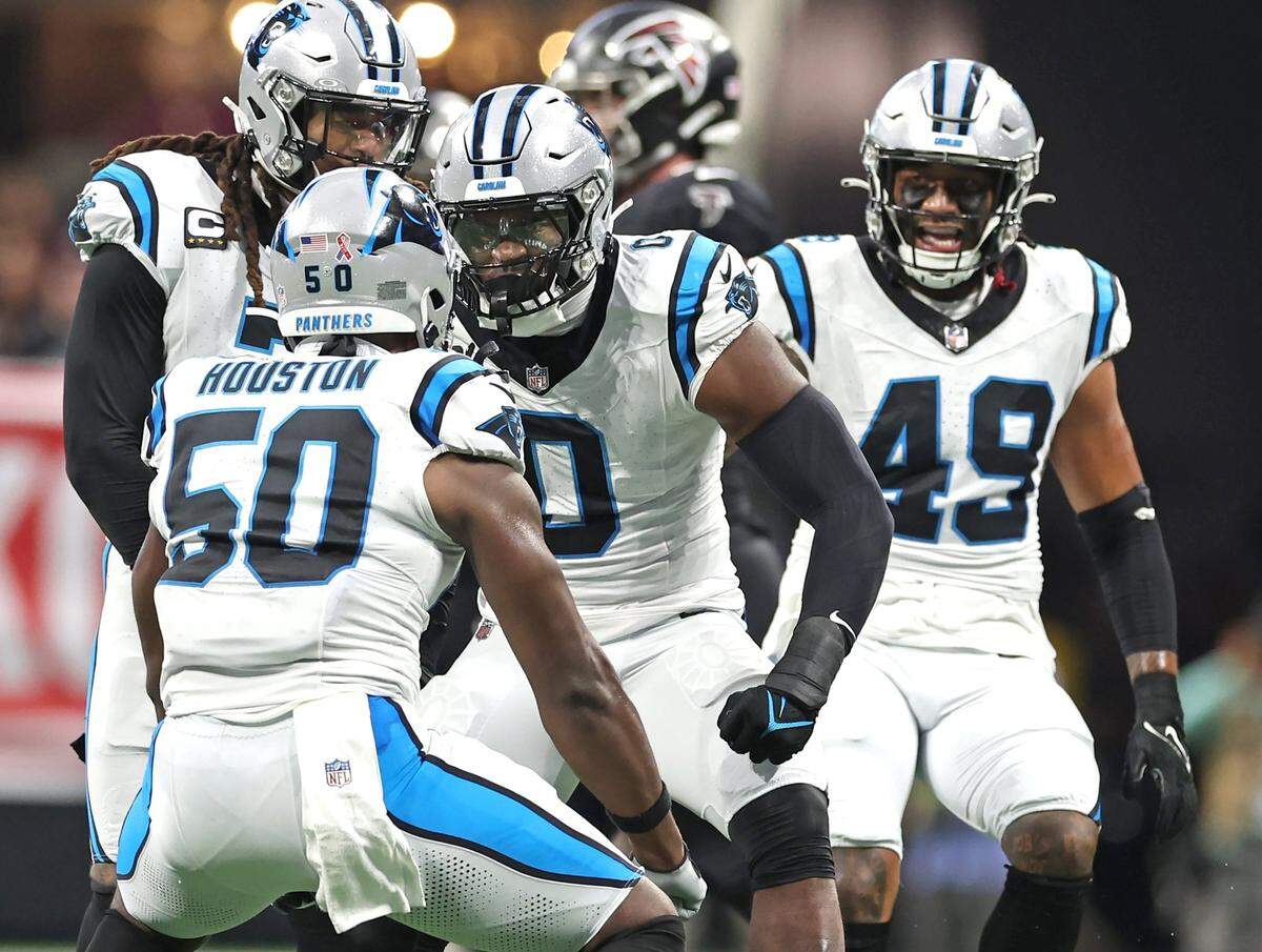 Carolina Panthers linebacker Brian Burns, center, celebrates a stop against the the Atlanta Falcons during first half action at Mercedes-Benz Stadium in Atlanta, GA on Sunday, September 10, 2023. The Falcons defeated the Panthers 24-10.