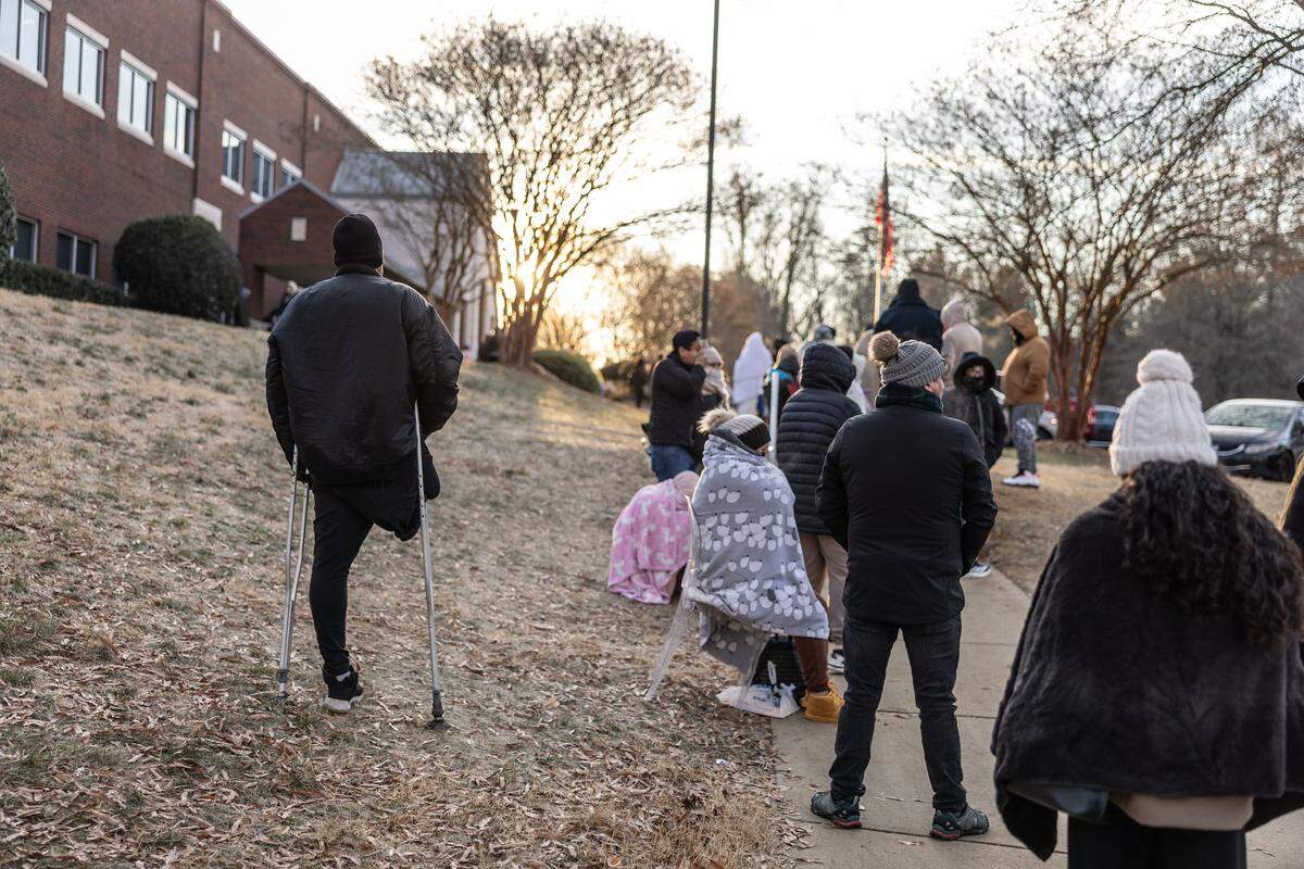 People wait outside the Department Homeland Security office in Charlotte, N.C., on Wednesday, January 21, 2026.